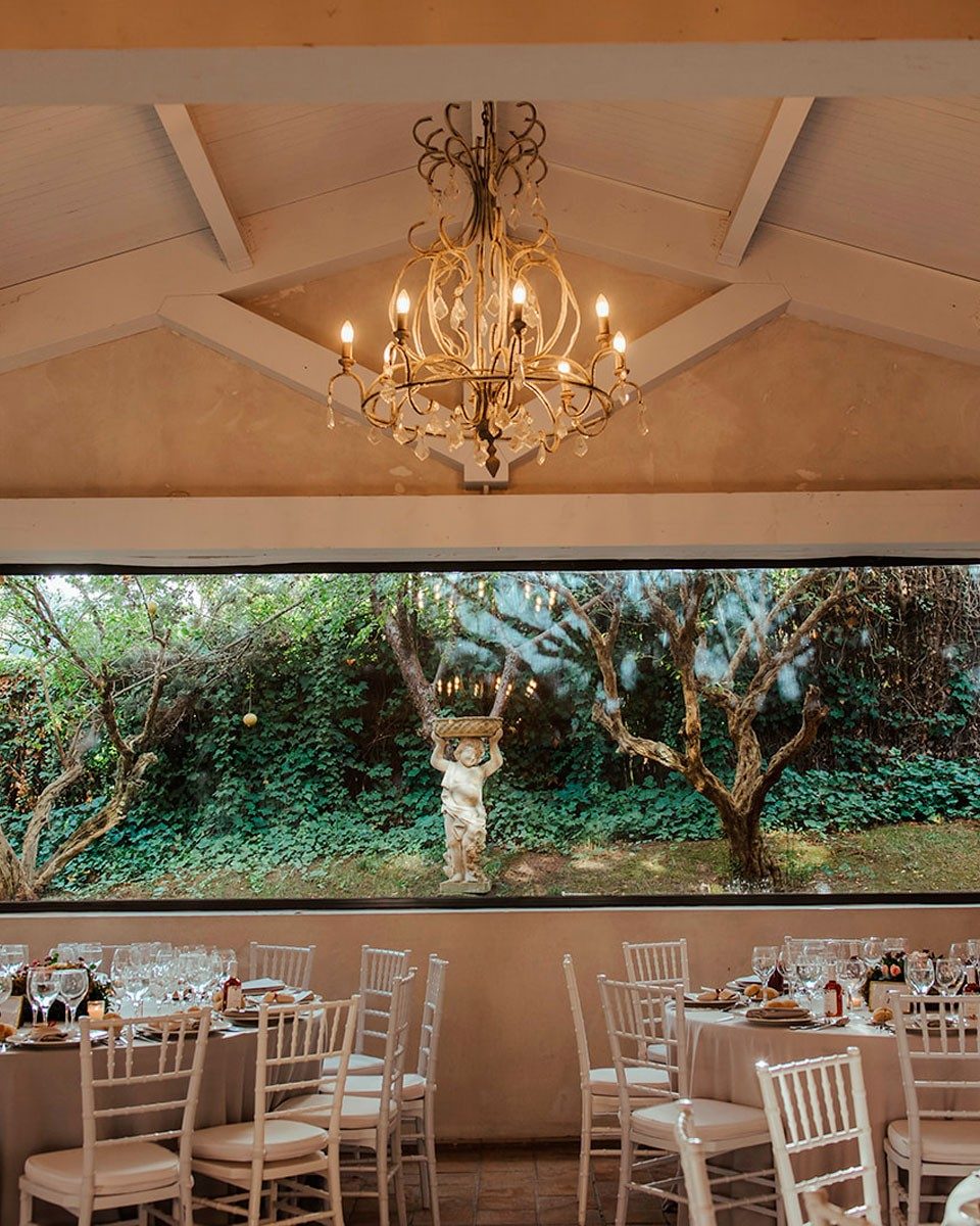 El Salón Jardín con grandes ventanales y mesas montadas